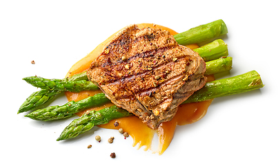 Image showing pork fillet steak and fried asparagus