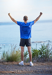 Image showing Success, freedom and running with back of man in nature for health, fitness and marathon training. Workout, exercise and winner with runner on mountain path for cardio, adventure and celebration