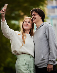 Image showing Selfie, happy and couple bonding in the city for memory, travel and on holiday together. Smile, date and woman taking a photo with a man on a vacation in an urban town for quality time and a break