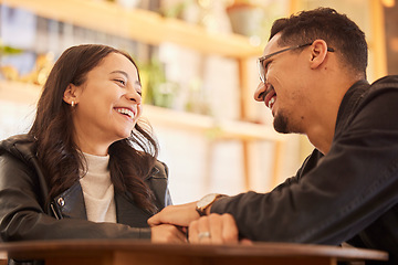 Image showing Couple, date and man happy with woman in a restaurant, coffee shop or cafe together bonding and funny conversation. Flirting, love and boyfriend relax with girlfriend on weekend break