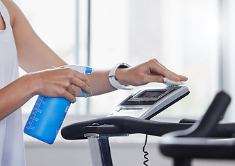 Image showing Sanitizer, disinfect and fitness person cleaning gym surface before exercise, workout and training for health and wellness. Hygiene, wipe and anti virus on a treadmill by hand spray equipment clean