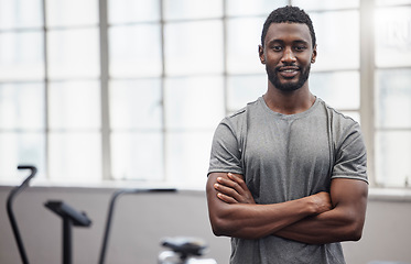 Image showing Happy black man smile in gym with arms crossed for training, exercise or workout in Nigeria. Portrait of strong bodybuilder, personal trainer and male in fitness club for coaching, sports or wellness
