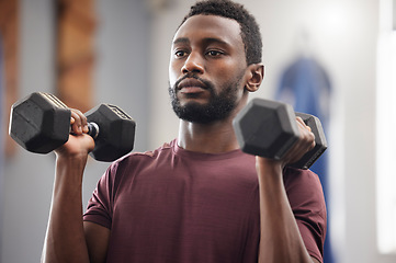 Image showing Black man, fitness and dumbbell exercise in gym for strong power, workout wellness and serious mindset. Bodybuilder, athlete and male training with weights for health, sports energy and muscle growth