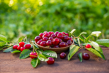 Image showing Cherries in a wooden bowl