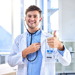 Image showing Thumbs up, stethoscope and cardiology with portrait of doctor for heart rate, healthcare and medical. Support, success and thank you with man and ok hand gesture for trust, medicine and agreement