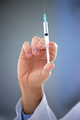 Image showing Hand, healthcare and closeup of needle, vaccine or shot for covid, disease or sickness on mockup. Doctor, syringe and zoom on science, innovation or medicine, cure or medical breakthrough at hospital