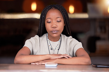 Image showing Depression, sad and woman with phone in coffee shop during breakup or fight on her cellphone. Depressed, moody and unhappy African female with mental health problem with mobile after argument in cafe