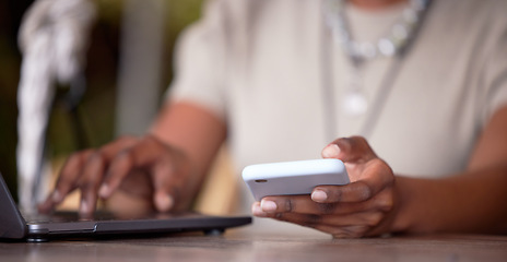 Image showing Black woman, hands and laptop with phone for social media, communication or chatting on table. Hand of African American female freelancer in remote work on computer and smartphone for multitasking