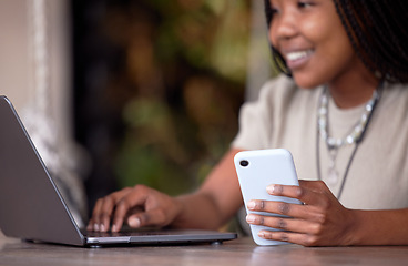 Image showing Black woman, phone and laptop in remote work at cafe for communication, social media or chatting. Hands of happy African American female freelancer with smile working on computer and smartphone