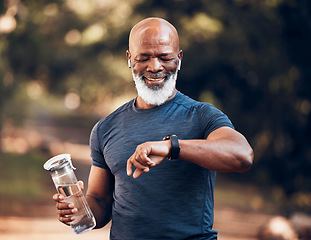 Image showing Black man, music and fitness watch with water bottle and smile outdoor for cardio time. Senior person happy in nature forest with smartwatch for exercise, workout and training for health and wellness