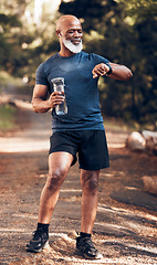 Image showing Black man, outdoor and fitness watch for exercise with water bottle for cardio time. Senior person in nature forest with smartwatch for health pulse check, workout music and body wellness training