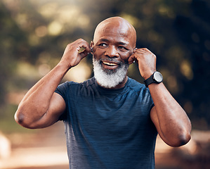 Image showing Black man, listening to music and smile for fitness and exercise outdoor in nature for cardio. Happy senior person with earphones for podcast during training or workout for body health and wellness