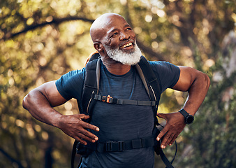 Image showing Fitness, hiking and black man backpacking in nature in a forest for exercise, health and wellness. Sports, athlete and happy senior African male in retirement trekking in the woods on adventure trail