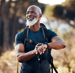 Image showing Hiking, man and smart watch for travel in nature forest for trekking, fitness and cardio exercise. Senior black person with backpack and gps clock outdoor in woods for adventure, health and wellness