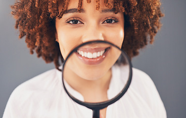 Image showing Beauty, magnifying glass and portrait with a black woman in studio to examine or check a skin routine. Wellness, investigation or skincare with an attractive young female searching her face for acne