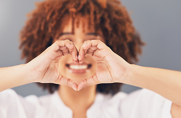 Image showing Heart, love and sign with hands of black woman for peace, support and emoji gesture. Confident, happy and smile with girl and self love shape for wellness, happiness or creative in studio background
