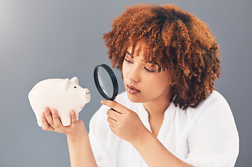 Image showing Magnifying glass, piggy bank or black woman with savings budget or financial profits growth on studio background. Curious, cash loan debt or broke girl searching for finances or money investment