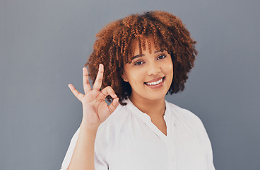 Image showing Perfect, satisfaction and portrait of a black woman with a hand isolated on a grey studio background. Happy, okay and an African girl with an emoji sign for success, winning and support symbol