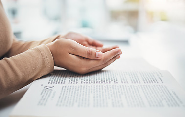 Image showing Religion, prayer and bible with hands of woman for worship, support and Christian faith. Believe, spirituality and God with girl praying over catholic holy text for wellness, respect and hope