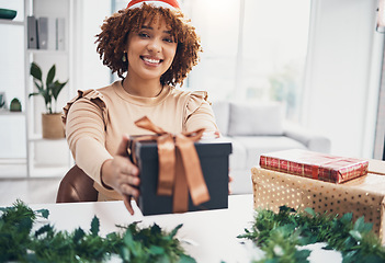 Image showing Christmas, gift and portrait with a happy black woman giving a box at an office party or event. December, holiday and present with a female employee in business holding a giftbox for celebration