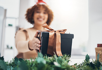 Image showing Christmas, gift and celebration with a business black woman giving a box at an office party or event. December, holiday and present with a female employee holding a giftbox while feeling happy