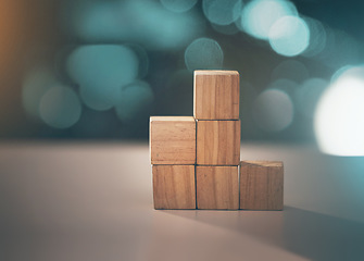 Image showing Building, business and blocks for investment, finance and growth on a table. Accounting, education and conceptual structure for profit, planning and investing in steps for progress on a desk