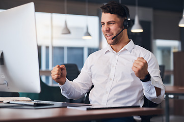 Image showing Man, call center and celebration for winning, sale or promotion in customer support or service at office desk. Happy male consultant celebrating in success for telemarketing, deal or discount on PC