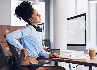 Image showing Back pain, call center and business black woman with injury, muscle ache and spine problem at desk. Customer support, telemarketing and tired female worker massage body for strain, tension and stress