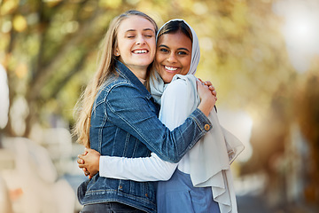 Image showing Hug, portrait and interracial and lesbian couple in the city with affection, happiness and freedom. Happy, smile and diverse women friends hugging with love, care and together in town for joy