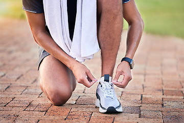 Image showing Closeup, outdoor and man with training, shoelace and workout for marathon, cardio and wellness. Zoom, male athlete and runner with sneakers, tying shoes or practice for performance, energy or balance