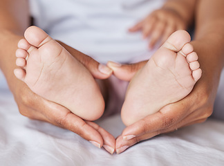 Image showing Closeup, feet and baby with mother, hands and care for kid, support and touch for bonding and playful. Zoom, mama and infant with health, wellness and newborn with female parent or child development