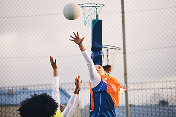 Image showing Netball, goal shooting and defense of a girl athlete group on an outdoor sports court. Aim, sport game and match challenge of a black person with a ball doing exercise and training in a competition