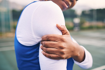 Image showing Arm injury, sport pain and netball athlete on a outdoor sports court with joint or muscle problem. Training, exercise and black woman hands holding arms with workout and wellness issue from accident