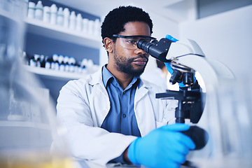 Image showing Microscope, science and black man working on study in laboratory for medical research analysis. Scientist, microbiology and biotechnology worker check investigation, innovation and dna pathology test