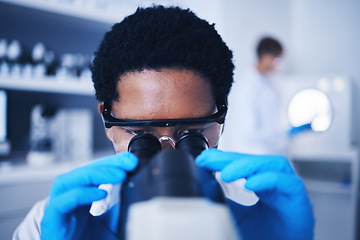 Image showing Microscope, science and black man face working in laboratory, medical research or virus analysis. Scientist, microbiology or medical worker check investigation, study innovation or dna pathology test