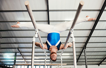 Image showing Gymnast man, bars and exercise with balance, strong body and focus for sports, vision and split legs in air. Gymnastics, athlete and training with muscle development, workout and low angle at gym