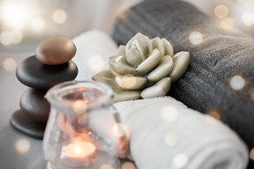 Image showing Rock, candle and towel in a spa for zen to relax in a stress free empty room with aromatherapy ambience. Luxury, salon and wellness with still life objects in an interior for relaxing stress relief