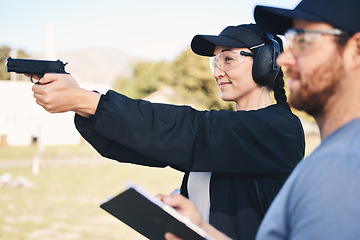 Image showing Gun range, target practice and woman holding a rifle for safety, security and police training. Field, exercise, and learning to fire at a outdoor academy with mentor and shooting gear for challenge