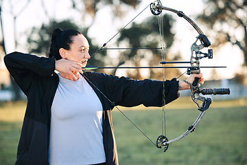 Image showing Hobby, learning and woman playing archery as a sport, outdoor activity and game in nature of France. Training, practice and girl with a bow and arrow for sports, competition and shooting at a park