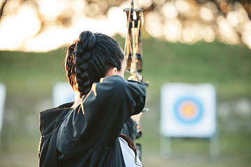 Image showing Archer, arrow target training and practice for archery competition, athlete challenge or competitive shooting. Sports field girl, bow hunting and woman focus on precision, aim or back view objective