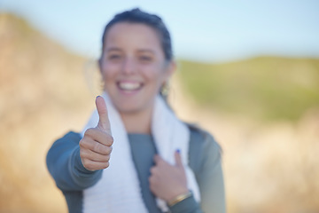Image showing Thumbs up, exercise and a sports woman on a blurred background outdoor for a cardio or endurance workout. Hand sign, fitness and running with a female athlete standing outside for health or wellness