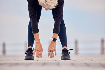 Image showing Woman stretching hands, legs and reaching ground for exercise, training and healthy wellness outdoors. Sports lady bending for warm up, body workout and fitness at beach promenade