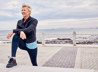 Image showing Senior woman, fitness and stretching at beach sidewalk for energy, wellness and happy workout on sky mockup. Elderly female, exercise and rest at sea promenade for training, sports run and motivation