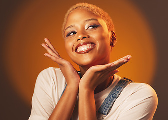 Image showing Playful, happy and beautiful black woman with hands isolated on a brown studio background. Crazy, funny and African girl with perfect makeup, cosmetics and excited to show face on a backdrop