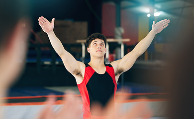 Image showing Gymnastics, performance and celebration of man in stadium after stunt for health and wellness. Sports, exercise and workout, training or gymnast celebrate after performing at competition at night.