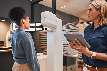 Image showing Eye exam machine, black woman and optometrist with tablet for vision test, eyesight and optical assessment. Ophthalmology, medical tech and optician in patient consultation for retina, eyes and lens