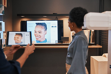 Image showing Optometry, glasses and black woman with television for choice of frames or spectacles at night in shop. Vision, ophthalmologist and optician with tablet to choose or shopping for prescription lenses.