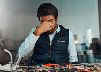 Image showing Tired, headache and man in technology repair, service and maintenance of electronic devices. Anxiety, migraine and technician with a problem, frustrated and stress while building electronics