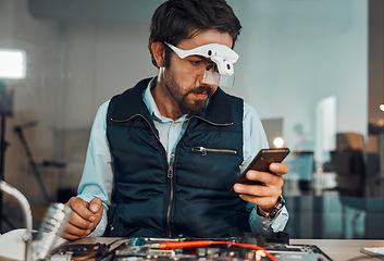 Image showing Chat, phone and man working in technology repair, technician workshop and engineeering. Communication, broken and serious handyman reading on a mobile online to fix an electronic appliance at work