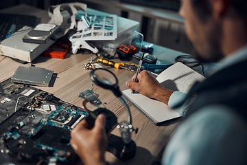 Image showing Technician, engineer or IT man repair motherboard, circuit board or electronic device in workshop or office at night. Person, startup and guy writing hardware notes for computer or technology in lab